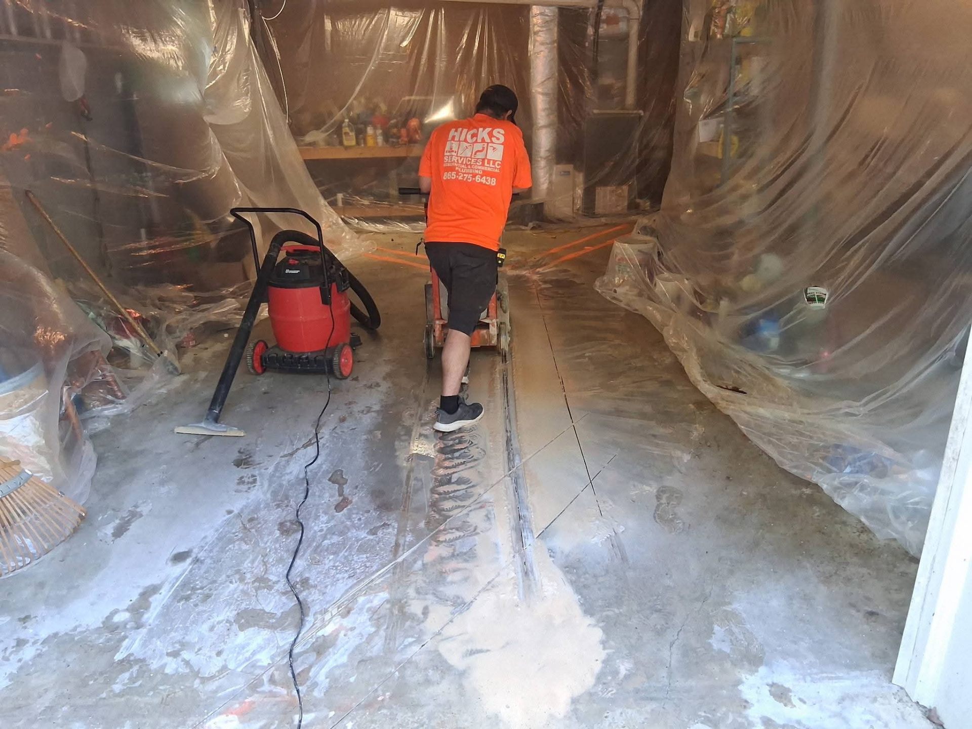 Hicks Services technician concrete cutting for plumbing repair