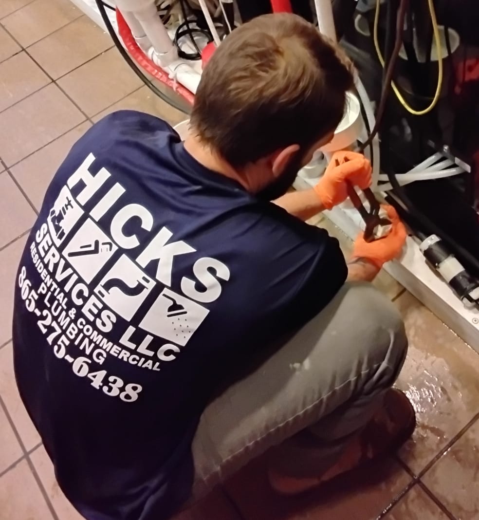 Hicks Services plumber working on site